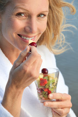 senior woman eating fruit salad