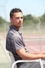 20 years old tennis arbitrator sitting on his armchair