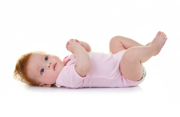 Baby lying down with red hair