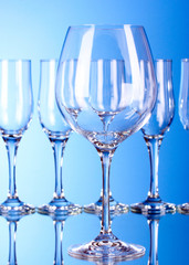 Few empty wine glasses on blue background