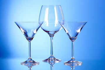 Few empty wine glasses on blue background