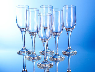 Few empty wine glasses on blue background