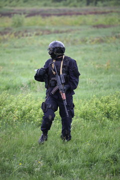 Special force soldier in black tactical suit