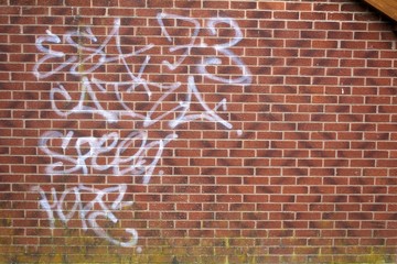 White Graffiti on Brick Wall