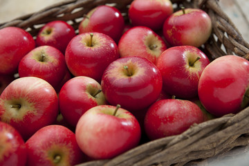 Loose red apples in wicker basket