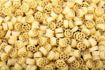 Raw Wagon wheel pasta noodles closeup macro