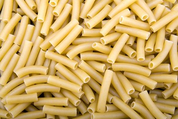 Raw ziti pasta noodles closeup macro