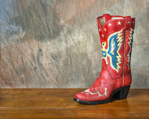 Red vintage cowboy boot on wood set