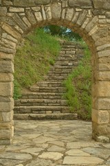 old stone staircase witn an arch