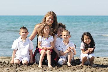 group portrait of childrens with teacher on beach