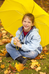 smiling girl under yellow umbrella