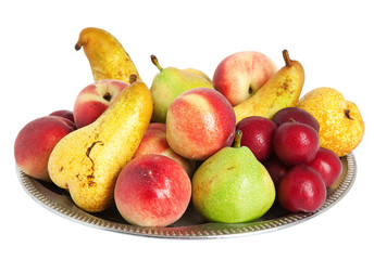 fresh fruits on a silver platter over white background.