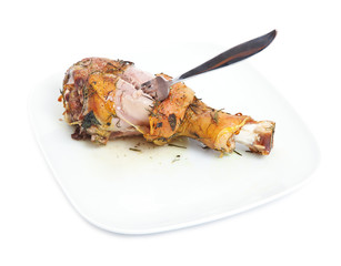 roasted turkey leg on a white plate .