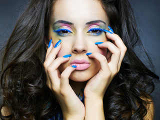 Beautiful woman with bright makeup and manicure