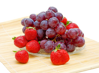 still life of fruit. fresh grapes and strawberries