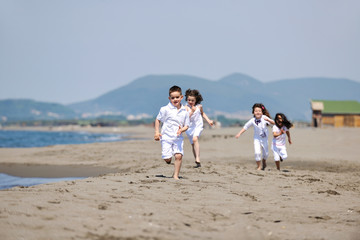 Fototapeta na wymiar happy child group playing on beach