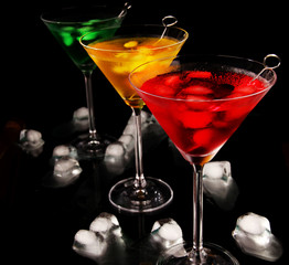 Martini drinks with ice on black background