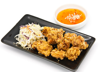 fried chicken in black plate with sauce