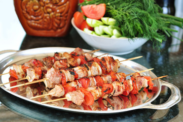 Delicious kebabs with onions and tomatoes on the dish