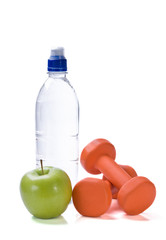 Bottle of water with fitness weights and apple