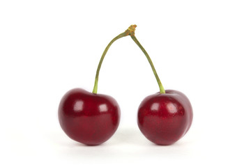 Two cherries on white background