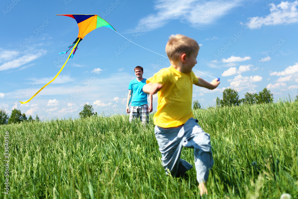 Wall mural father with son in summer with kite