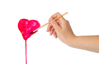 hand with brush drawing shape of heart isolated on white