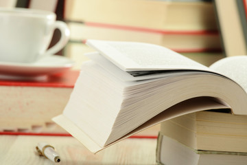 Composition with books and cup of coffee on the table