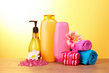 A set of bath cosmetics on yellow background