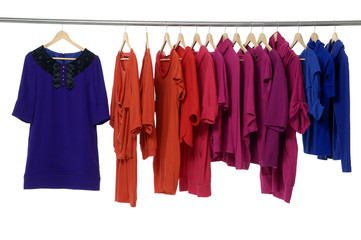 colored fashion cloth hanging on hangers