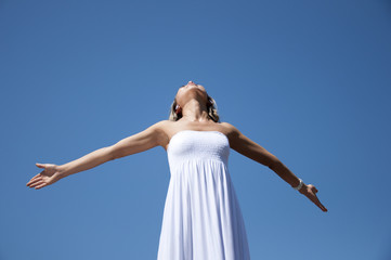 Fototapeta na wymiar woman having stretched hands aspires in the sky