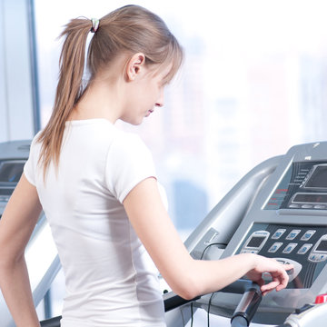 Young woman at the gym exercising. Running