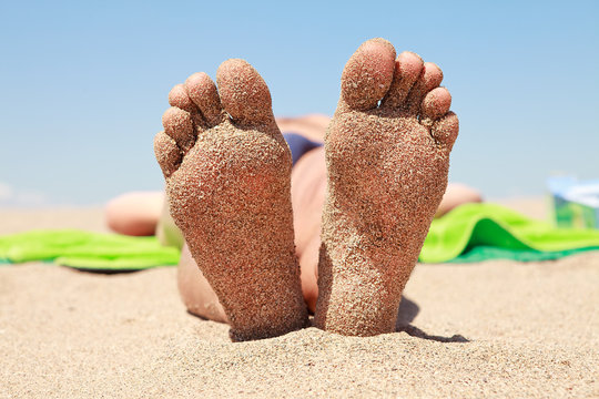 Bottom Of Male Feet Covered With Sand