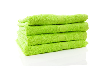 pile of green towels over white background