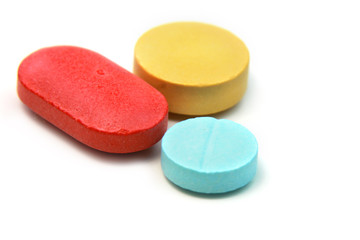 Three different colored tablets isolated on white background