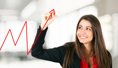 Businesswoman drawing a rising arrow