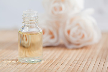 Roses and a glass phial with on a focus on the phial