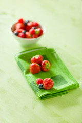Berries on green wooden table