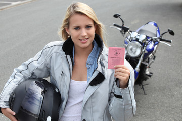 Young woman with motorcycle and French license