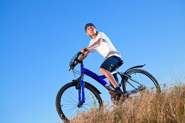 Fototapeta na wymiar The boy with a bicycle