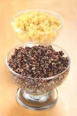 Cooked red and white quinoa in glass bowls