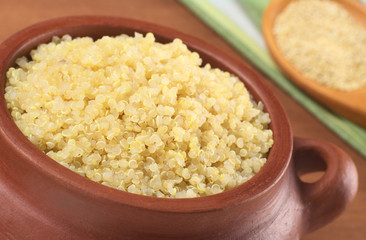Cooked white quinoa in rustic bowl