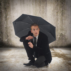 Young business man holding an umbrella