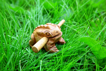 Asian handmade wealthy frog on green grass background