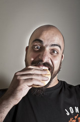 man with bread in his mouth