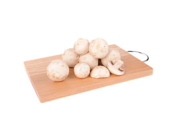 mushrooms on the cutting board isolated on the white background