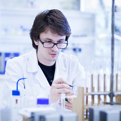 young male researcher carrying out scientific research in a lab