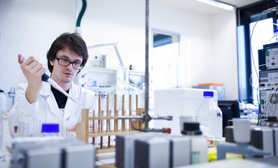 young male researcher carrying out scientific research in a lab