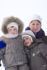 Mother and sons in casual winter clothes