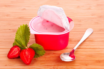 yogurt and strawberry on a wooden background